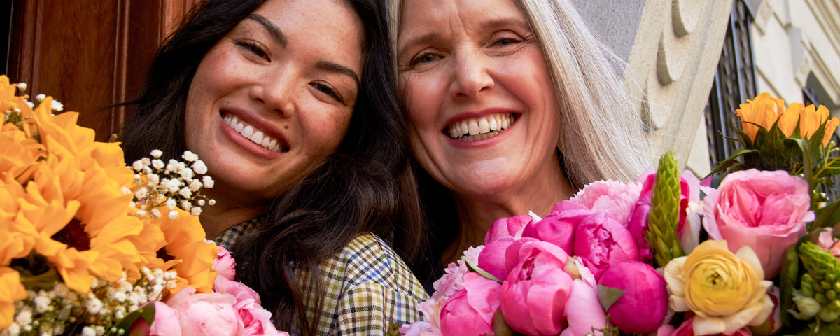 Girl and he rmother celebrating Mothers Day 2022 with flowers for Mother's Day
