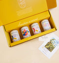 Open yellow box containing four Brightleaf tea cans with a card on a beige background