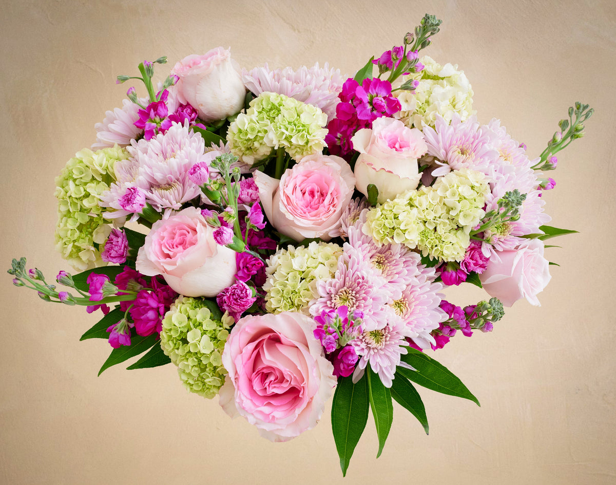 Bouquet of pink and green flowers on a beige background