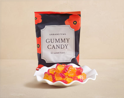 Packaged gummy candy with a decorative label on a beige background