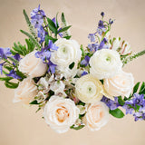 Bouquet of white and purple flowers on a beige background