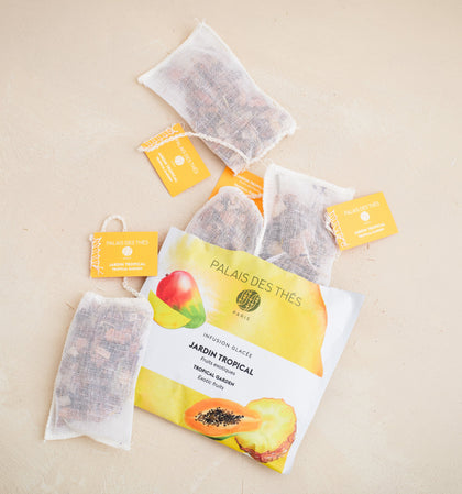 Tea bags with 'Palais des Thès' packaging on a beige background